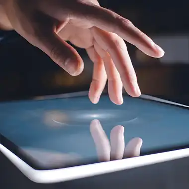 Close-up of hand interacting with a touchscreen kiosk for event engagement